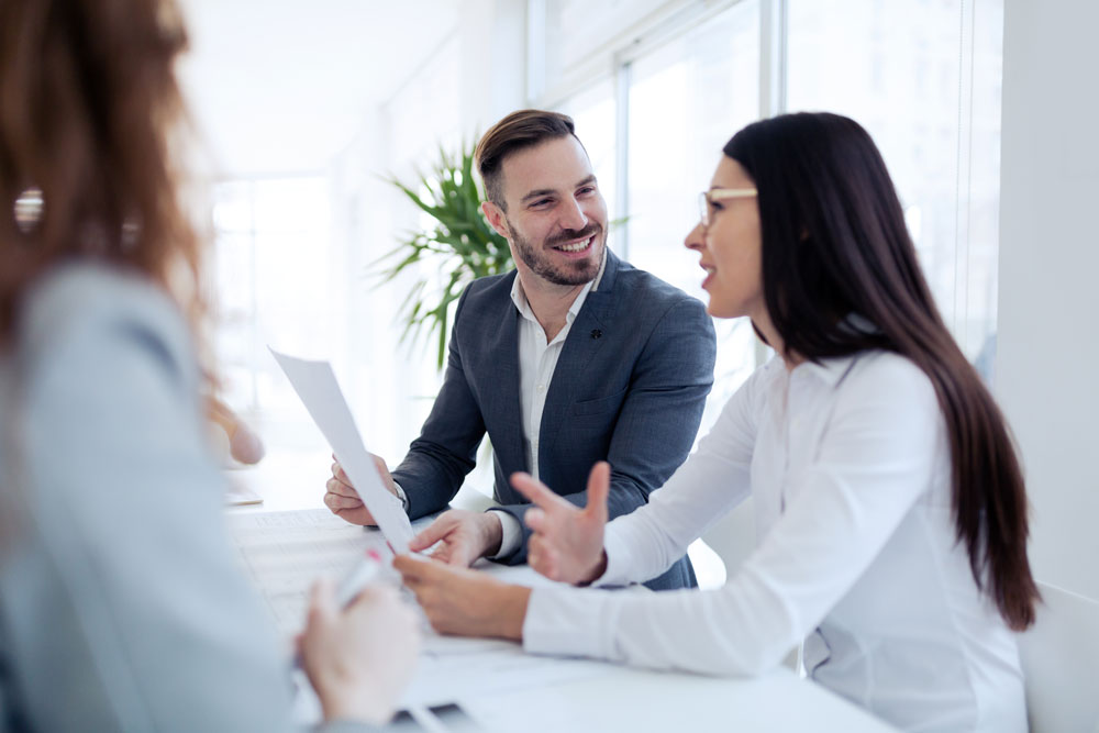 smiling colleagues at business meeting